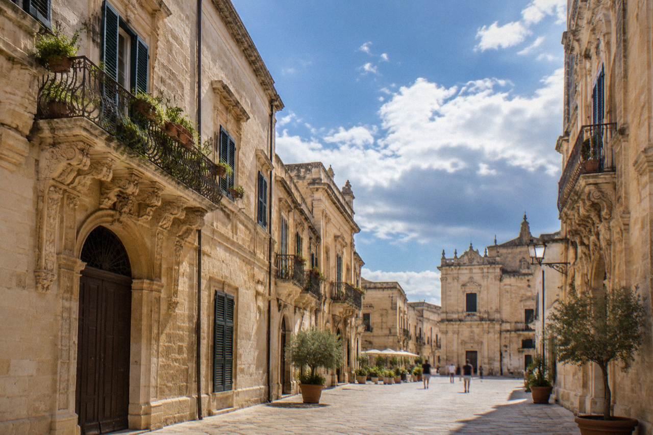 Golden limestone buildings along a sunlit street in the old centre of Lecce
