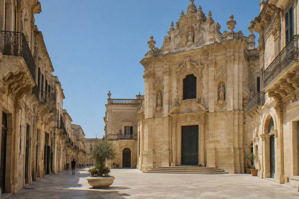 Ornately carved baroque facade in golden stone in Lecce's historic centre