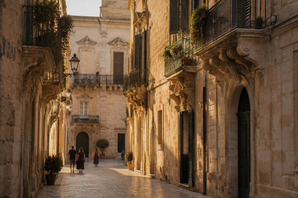 A quiet evening street of golden stone buildings and baroque balconies in Lecce's old town