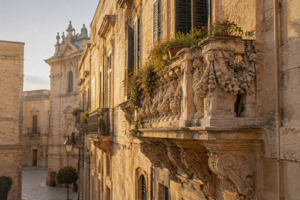A carved baroque balcony with stone garlands on a palazzo in Lecce