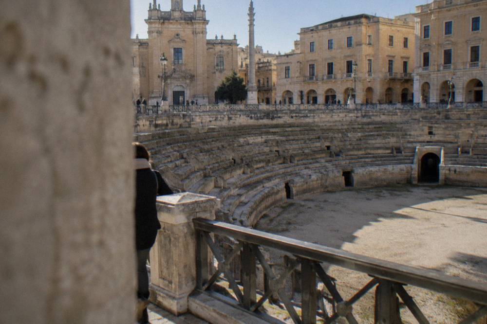 The sunken Roman amphitheatre seen from street level in Piazza Sant'Oronzo in Lecce