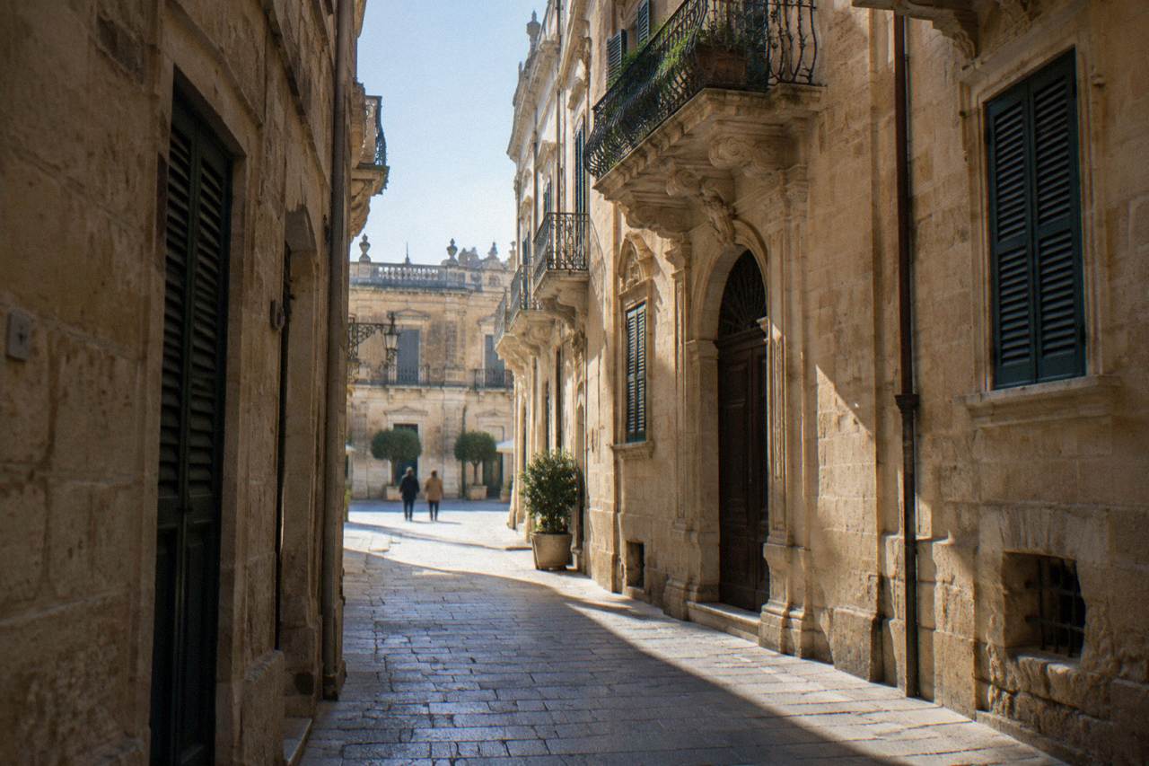 A narrow stone lane in Lecce's old town with warm limestone walls and shuttered windows
