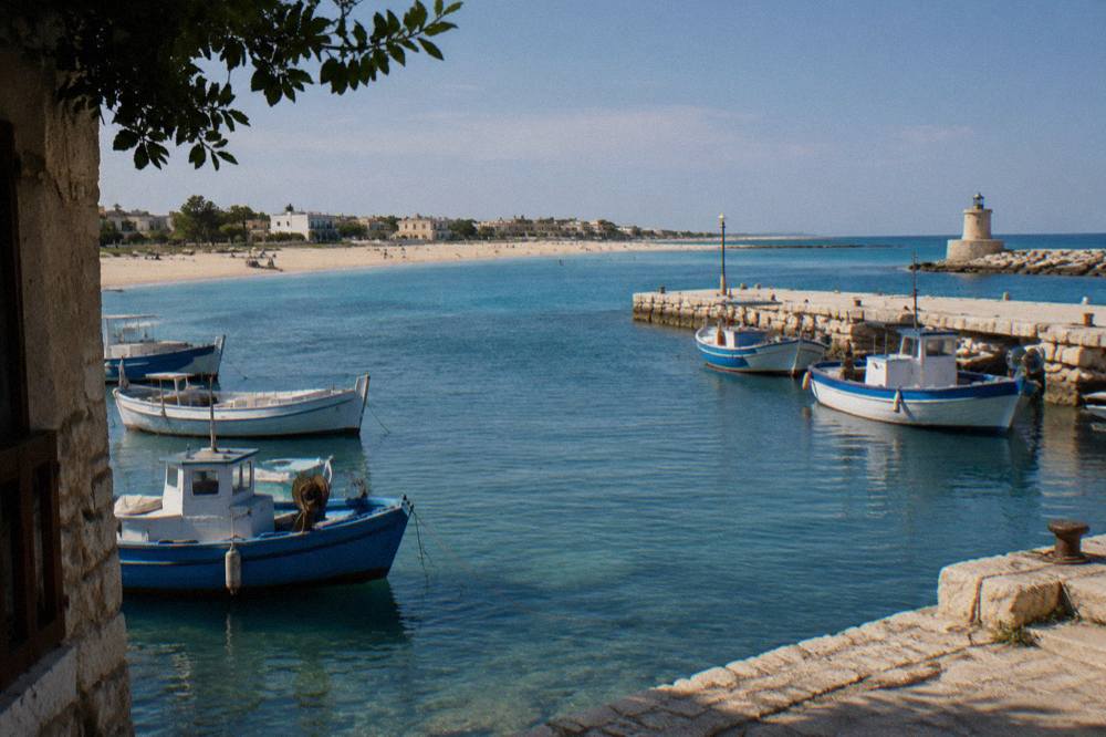 A small Adriatic harbour with fishing boats moored beside a stone jetty