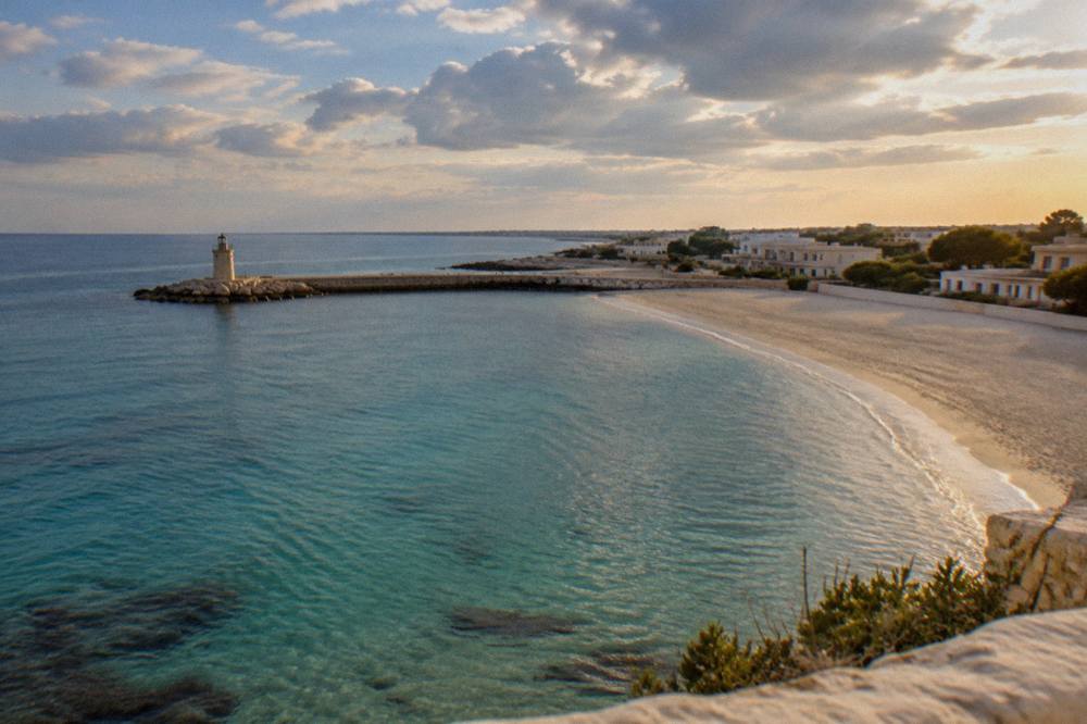 Evening light over a calm sea with a empty sandy foreshore