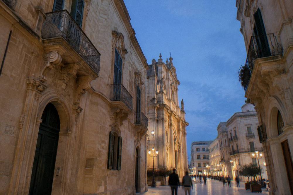 The edge of Lecce old town where narrow baroque streets meet wider modern shopping avenues
