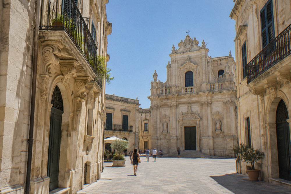 Interior of a baroque church with side altars in pale stone