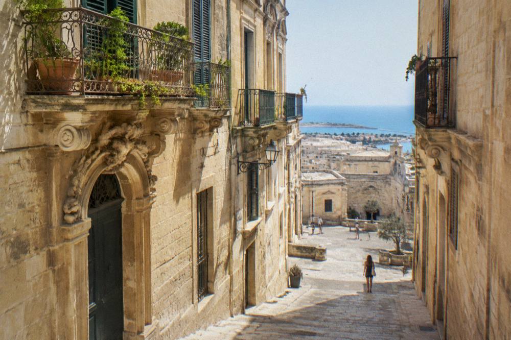 Coastal town rooftops and sea seen from above on the Salento peninsula