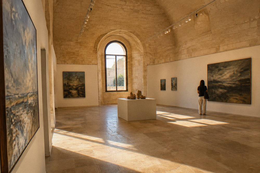 A gallery room inside Castello Carlo V prepared for a temporary exhibition