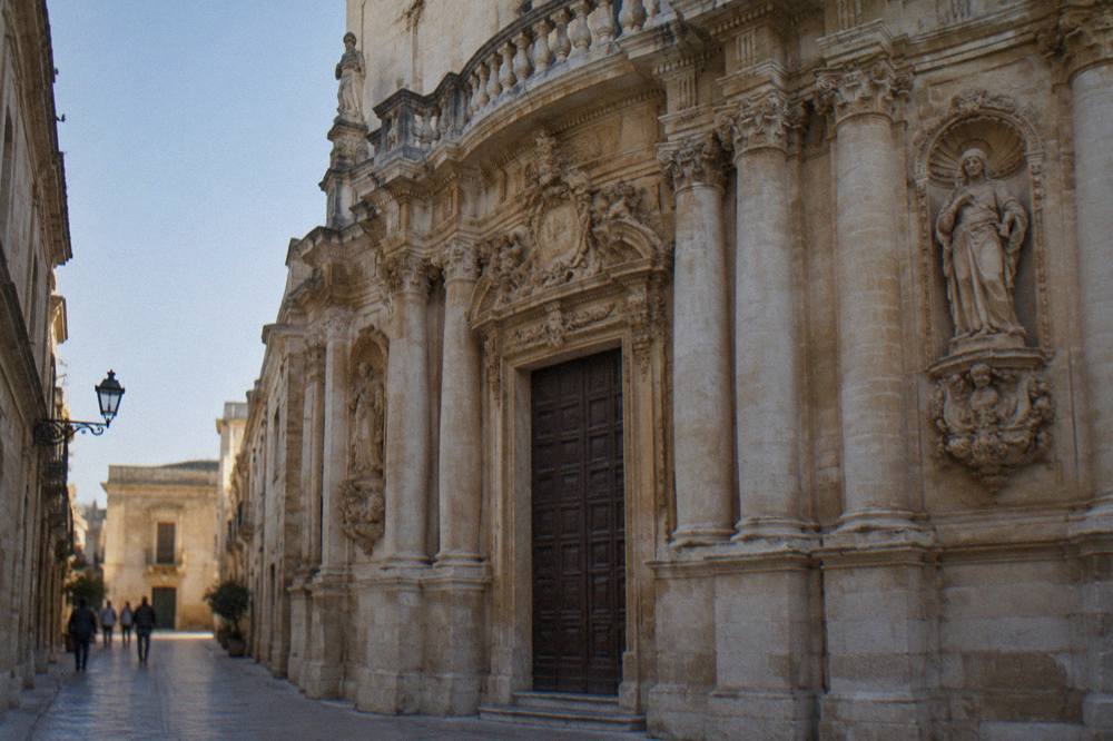 Detail of stacked columns and carved figures on the lower facade of the Chiesa di San Matteo