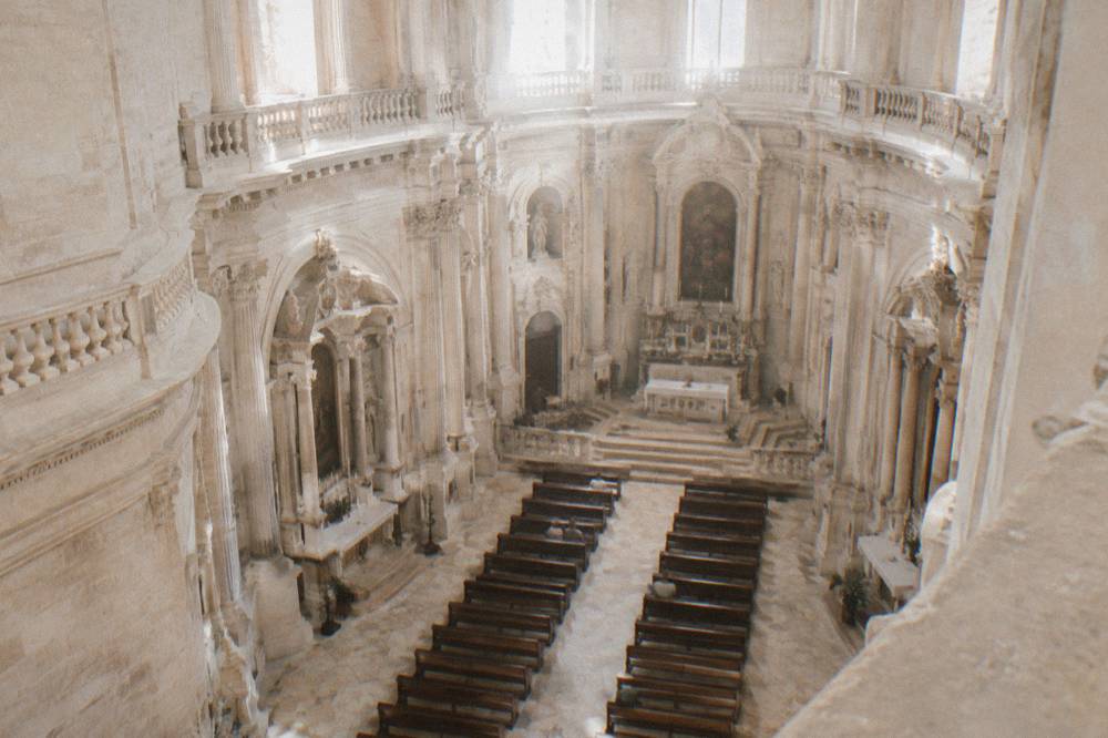 The elliptical interior of the Chiesa di San Matteo with curved side altars in pale stone
