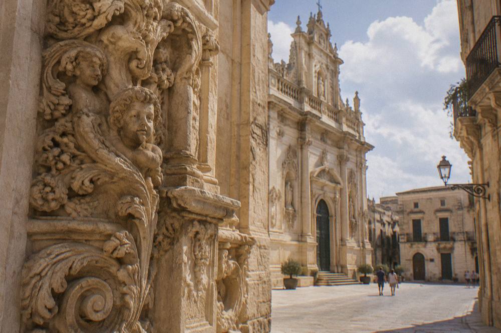 Close view of carved limestone ornament on a church facade in Lecce
