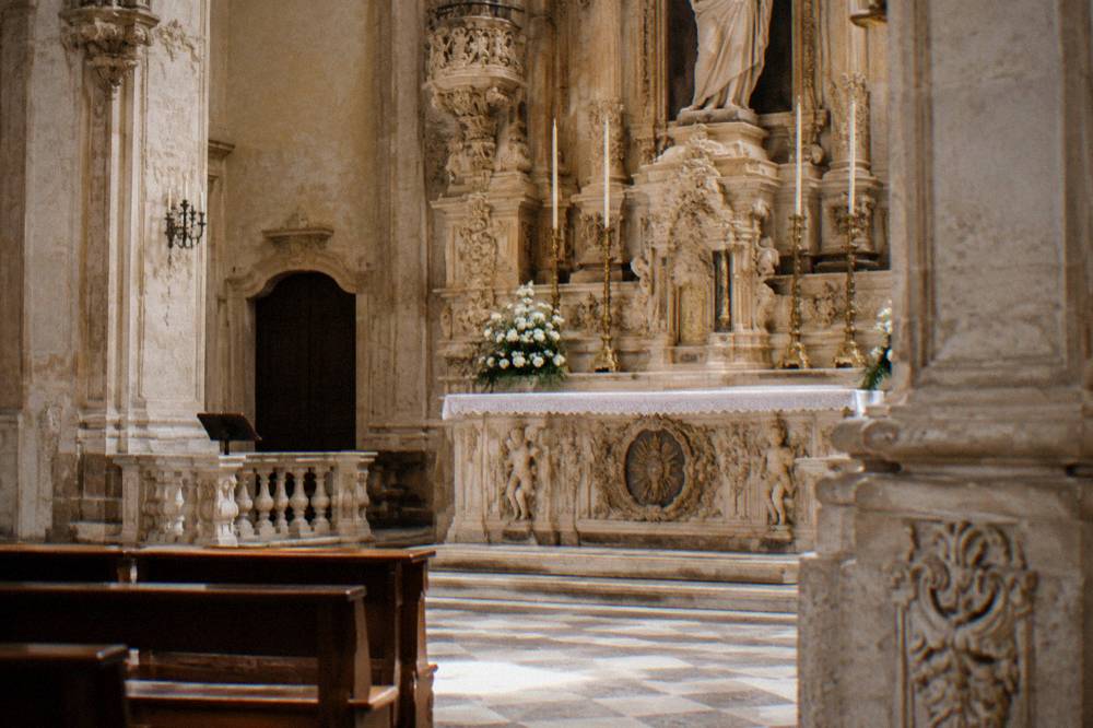 Stone altar with carved decoration inside a baroque church