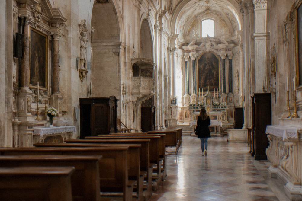 Sunlit nave of a small baroque church with side altars