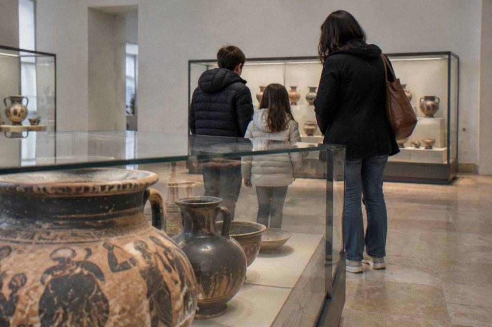Family looking at ancient pottery displayed in an archaeology museum gallery