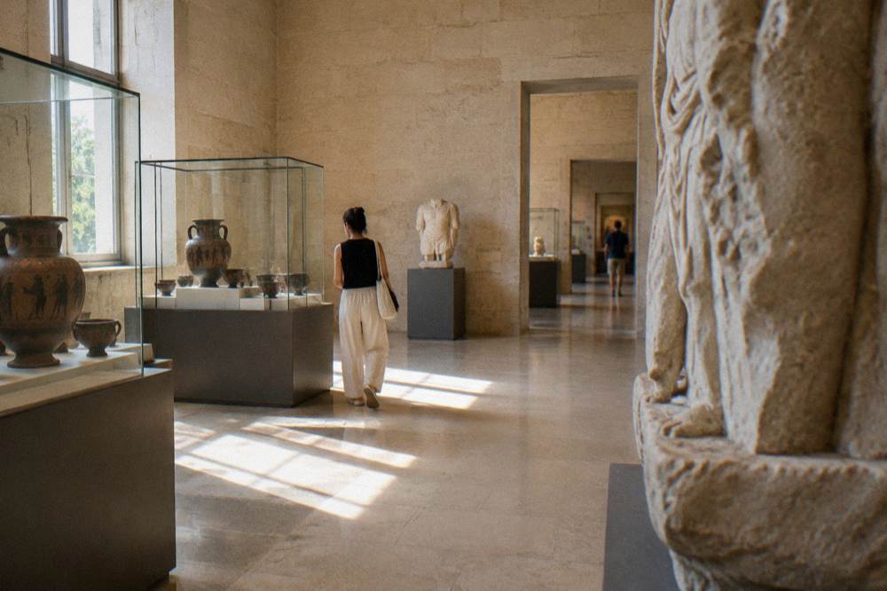 Museum hall with display cases and stone walls