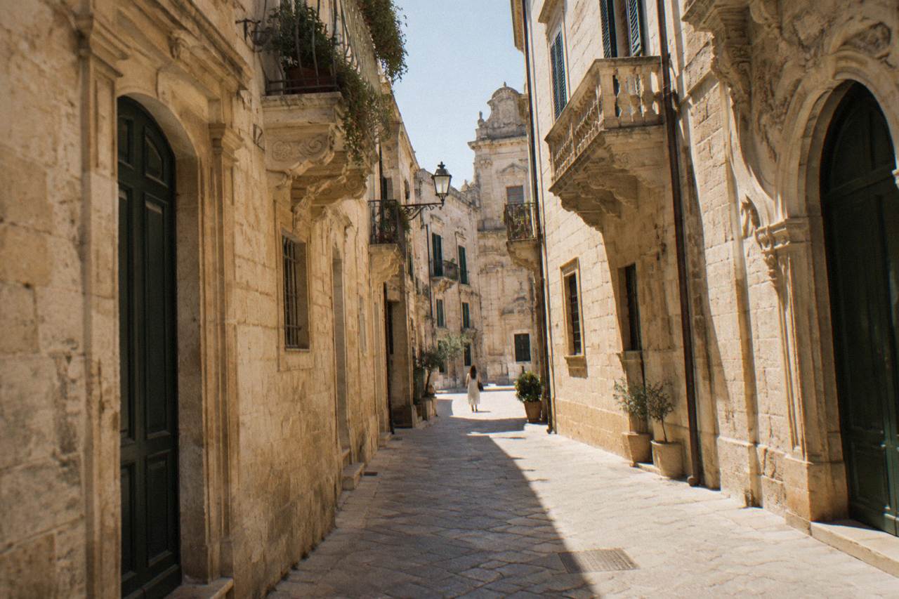 A quiet stone street in the old Jewish quarter of Lecce with warm limestone walls