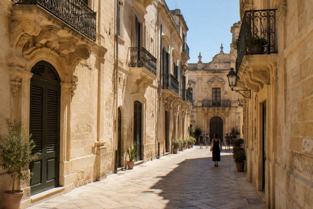 Evening light on a narrow Lecce street with lit windows