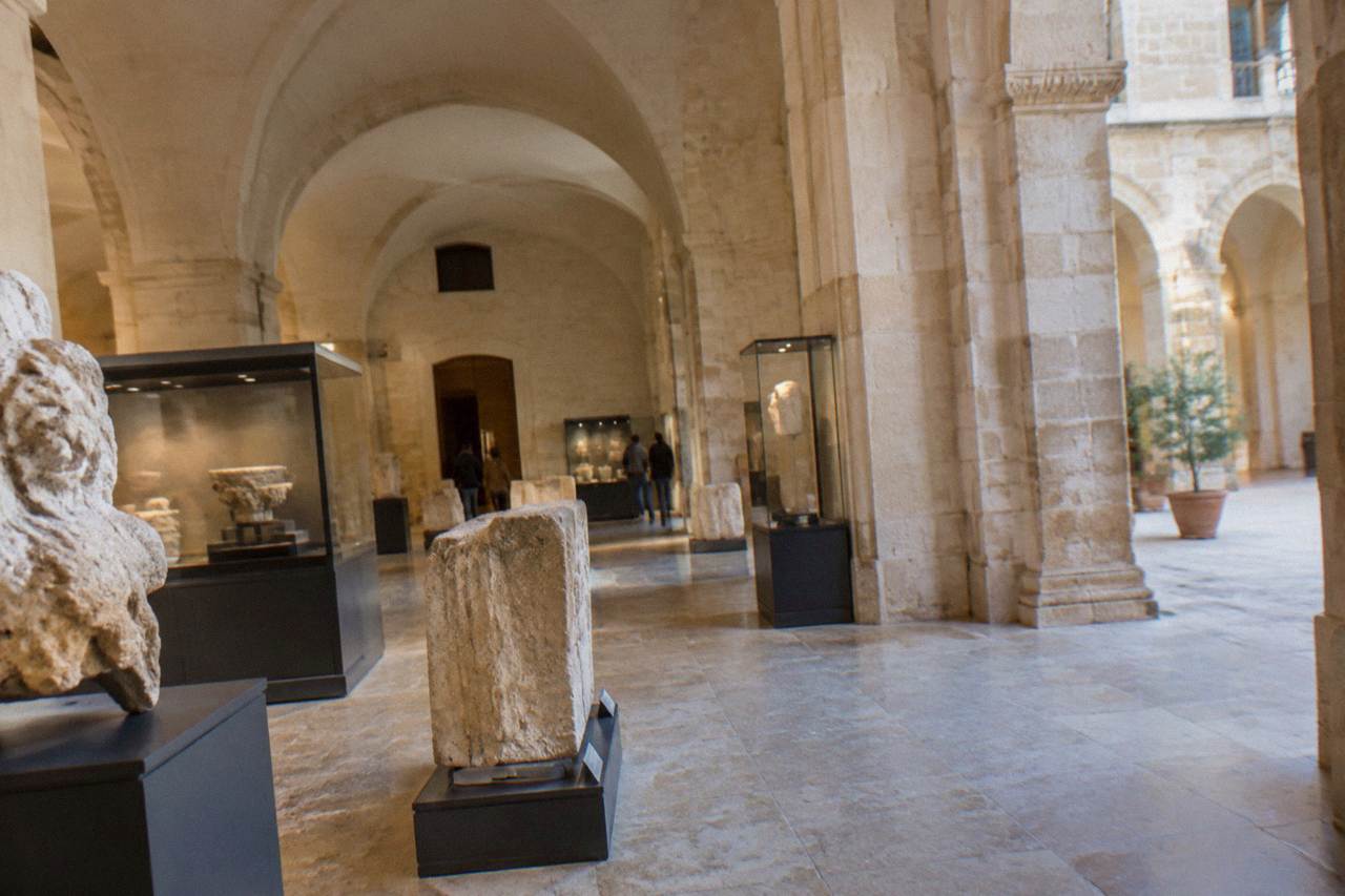 Interior gallery of a city history museum with stone fragments and display cases