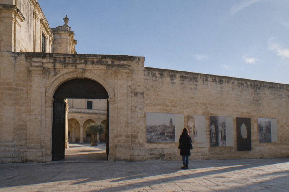 Visitor reading wall panels about the history of a southern Italian city