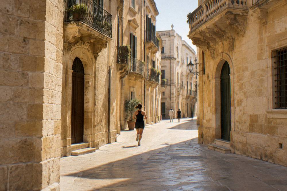 Golden limestone street corner in Lecce at late afternoon