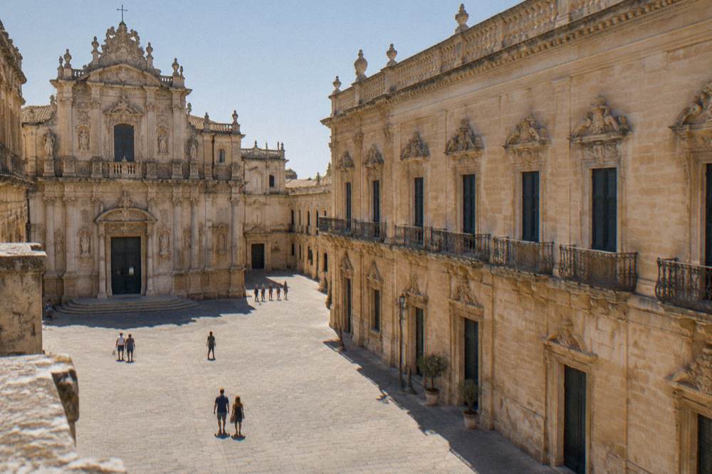 A church facade and a palace facade facing each other across a stone square