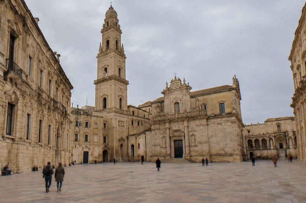 A wide view of Piazza del Duomo showing the cathedral, bell tower and seminary together