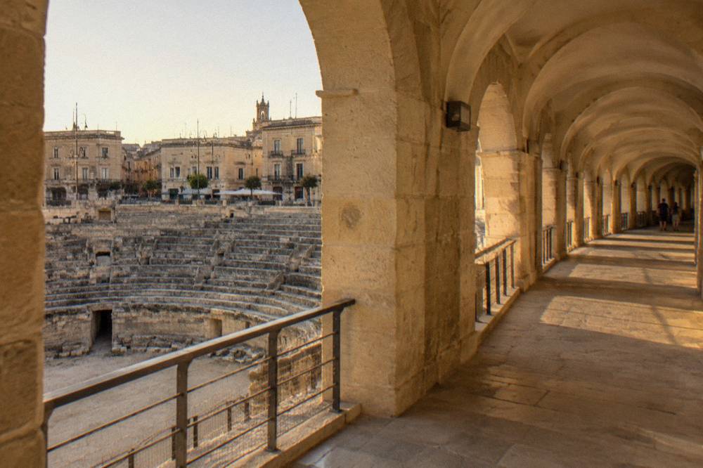 An arched corridor of pale Lecce stone inside the restored Roman Amphitheatre