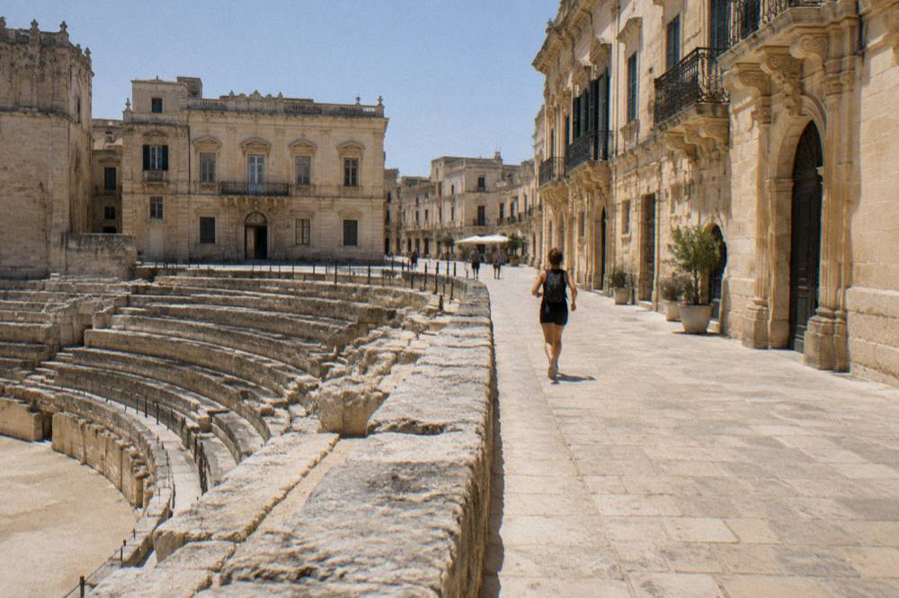 The point where the excavated seating rows of the arena stop against the paving of the modern square