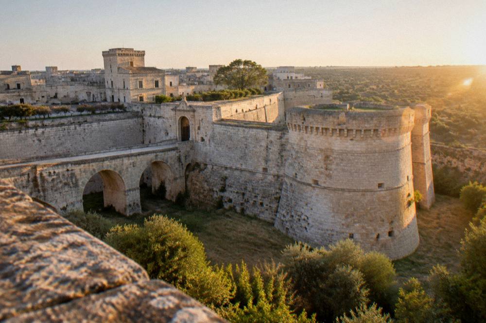 Golden late afternoon light on stone walls and towers of a small fortified village