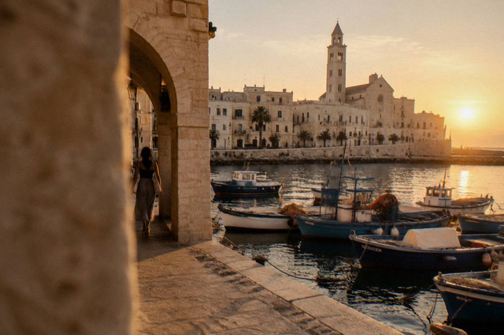 Evening light on historic buildings above a harbour with moored boats