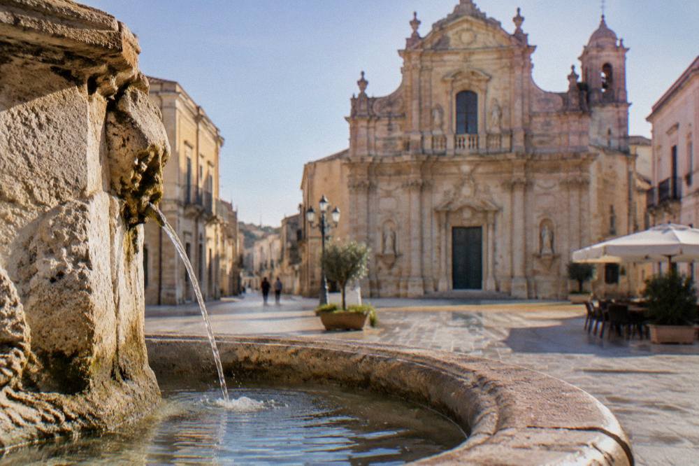 Sunlit square in a small Italian town in early morning light