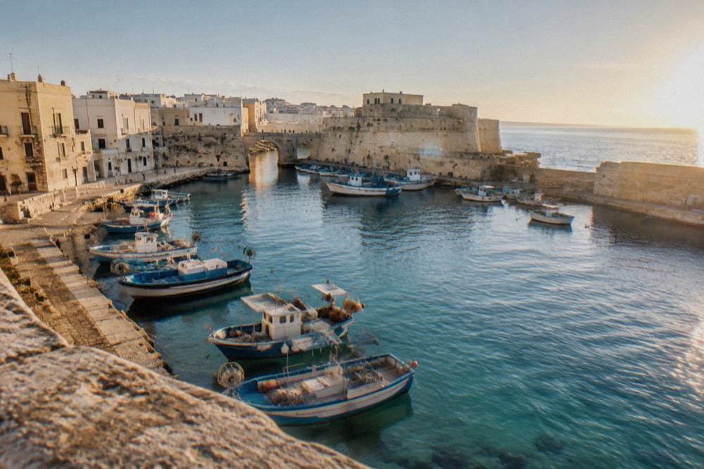 Fishing boats moored in Gallipoli harbour beside stone quays