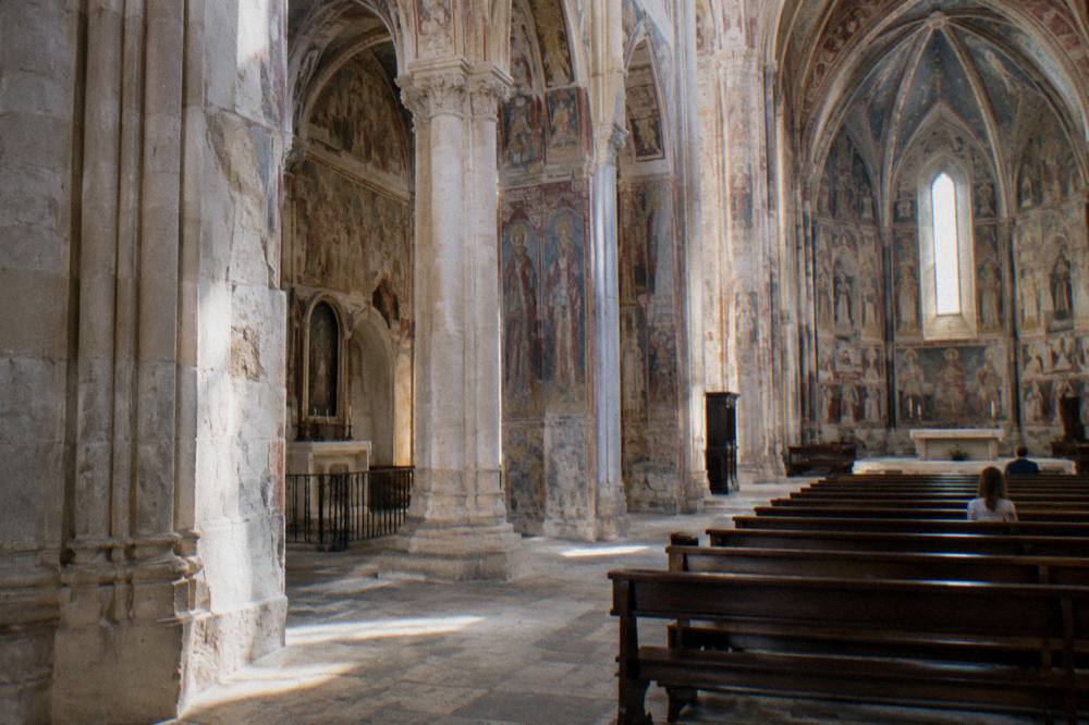 The interior of a frescoed Gothic church in Galatina with tall columns
