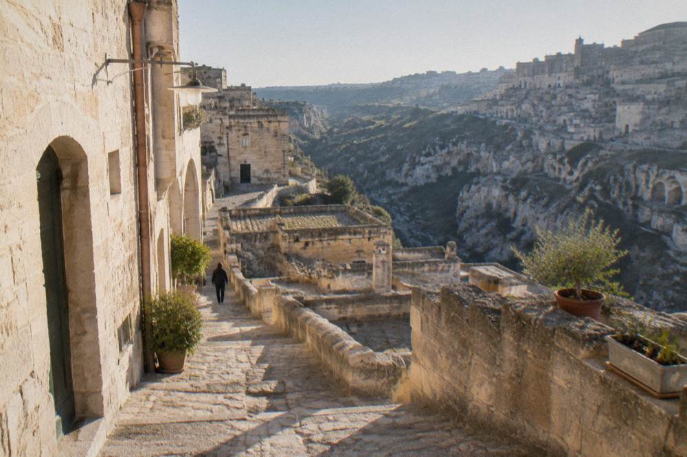 Stone steps and narrow lanes climbing between old cave dwellings in a southern Italian town