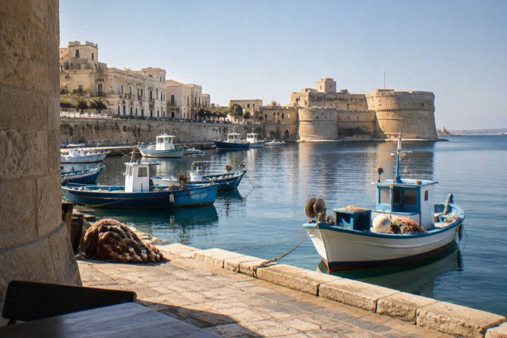 Fishing boats moored in a small harbour beside stone quays