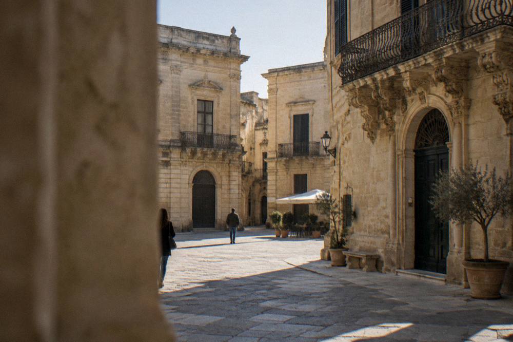 Golden limestone buildings glowing around a small square in Lecce
