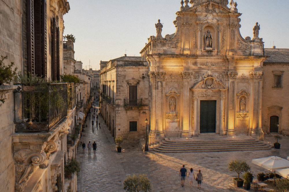 A baroque church facade lit by warm evening floodlighting
