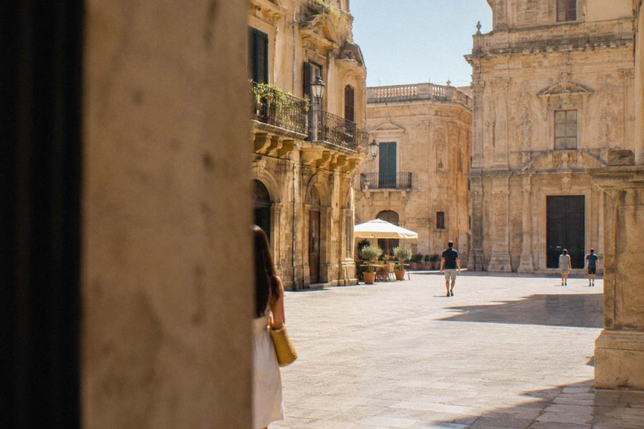 Golden baroque facades around a sunlit square in Lecce old town