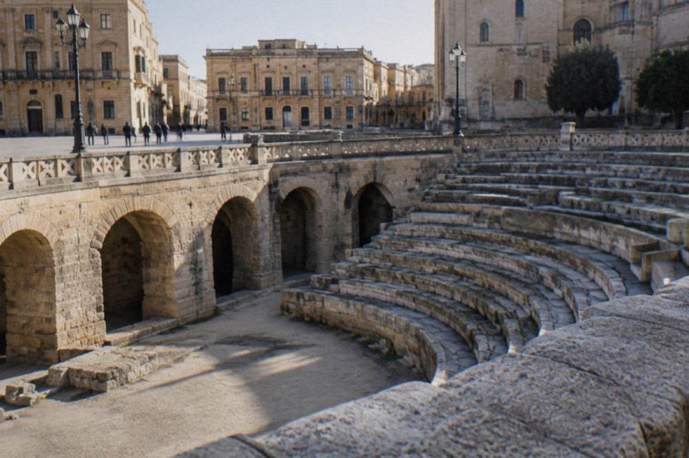 Sunken Roman amphitheatre arcades below the pavement of a Lecce square