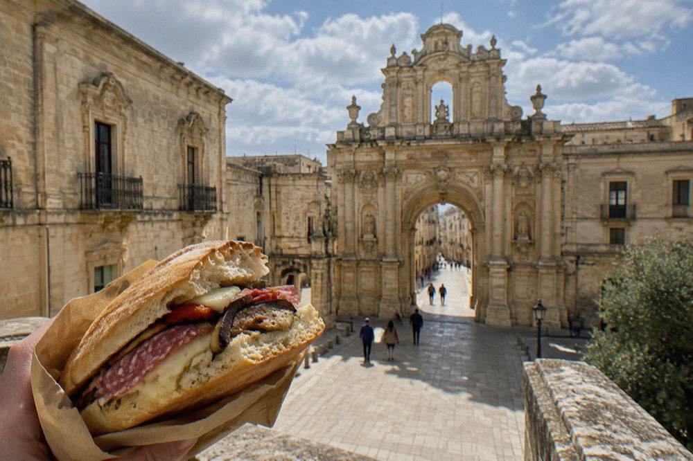 A split puccia loaf filled with salami, cheese and grilled vegetables