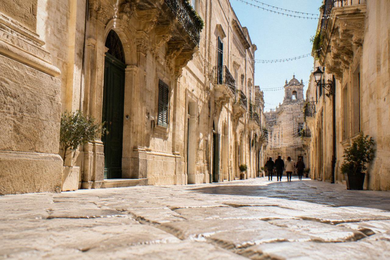 A baroque limestone street in Lecce decorated with strings of Christmas lights