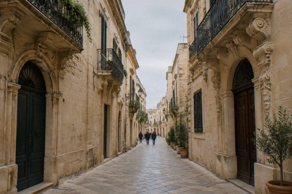 Narrow cobbled lane in Lecce lined by golden stone buildings