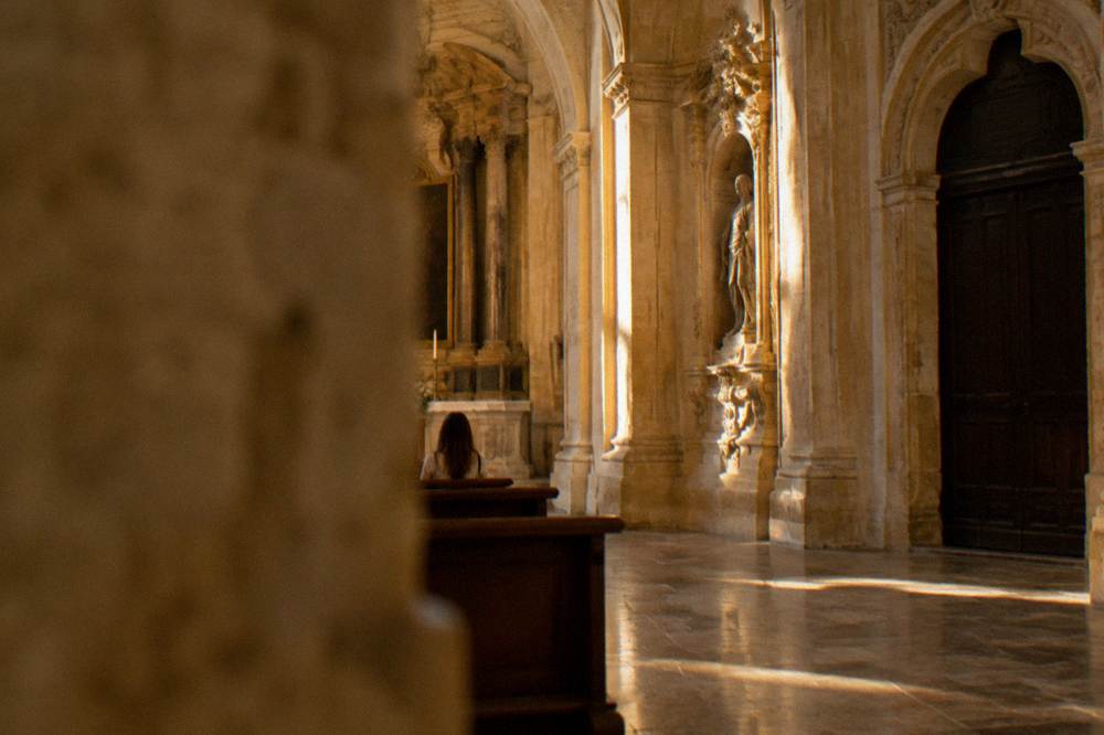 Interior arch of a Baroque church with a stone floor
