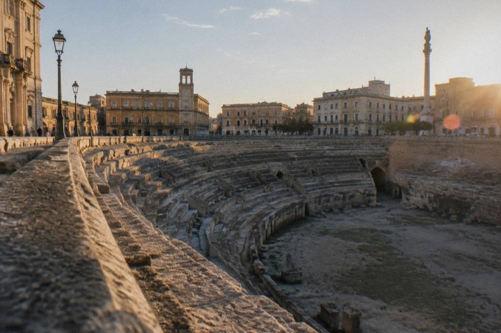Stone ruins of an ancient archaeological site under a wide sky in the Salento countryside