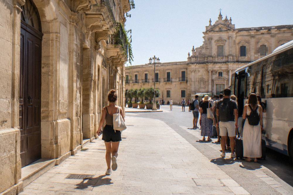 Bus stop with summer passengers waiting to travel from Lecce toward the coast