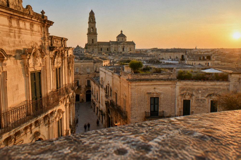 Wide view of Lecce rooftops at golden hour in summer