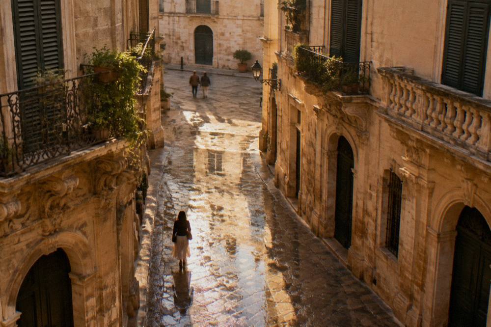 Wet cobblestone street in Lecce old town reflecting baroque windows