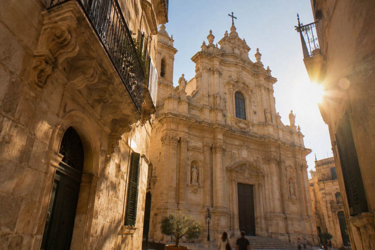 Golden limestone facade of a baroque church glowing in warm afternoon light