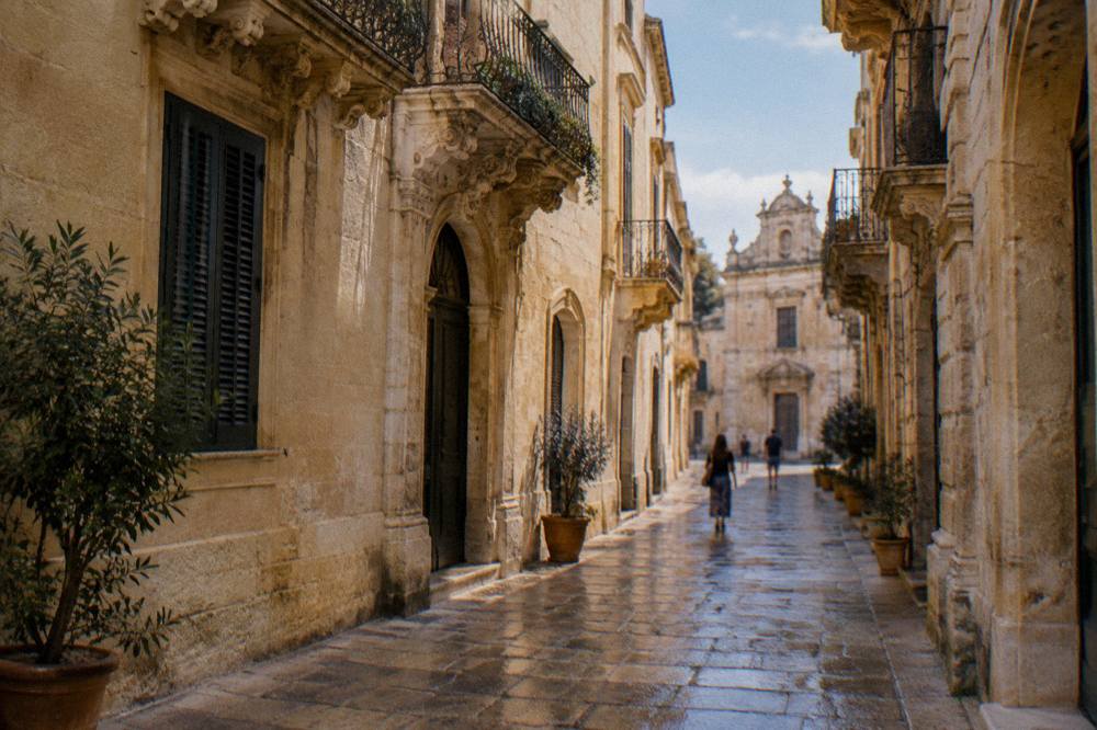 A narrow car-free limestone street in Lecce's old town