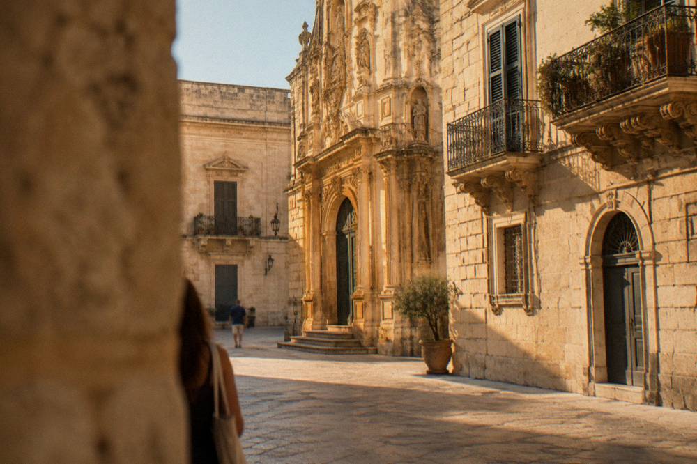 A baroque limestone facade in Lecce lit by warm evening light